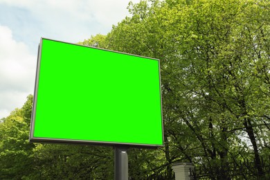Chroma key compositing. Big empty billboard with green screen outdoors. Mockup for design
