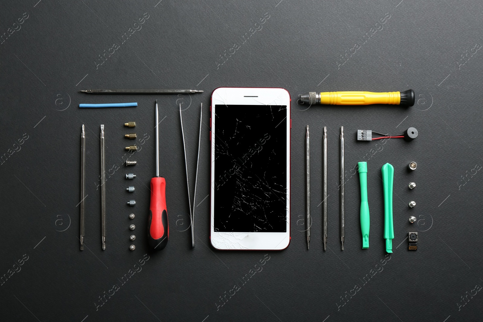 Photo of Flat lay composition with broken mobile phone and repair tools on color background