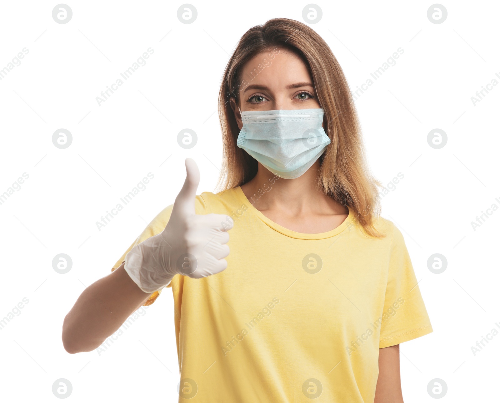 Photo of Young woman in medical gloves and protective mask showing thumb up on white background