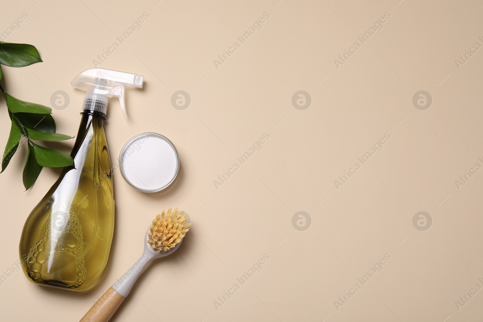 Photo of Bottle of cleaning product, brush and baking soda on beige background, flat lay. Space for text