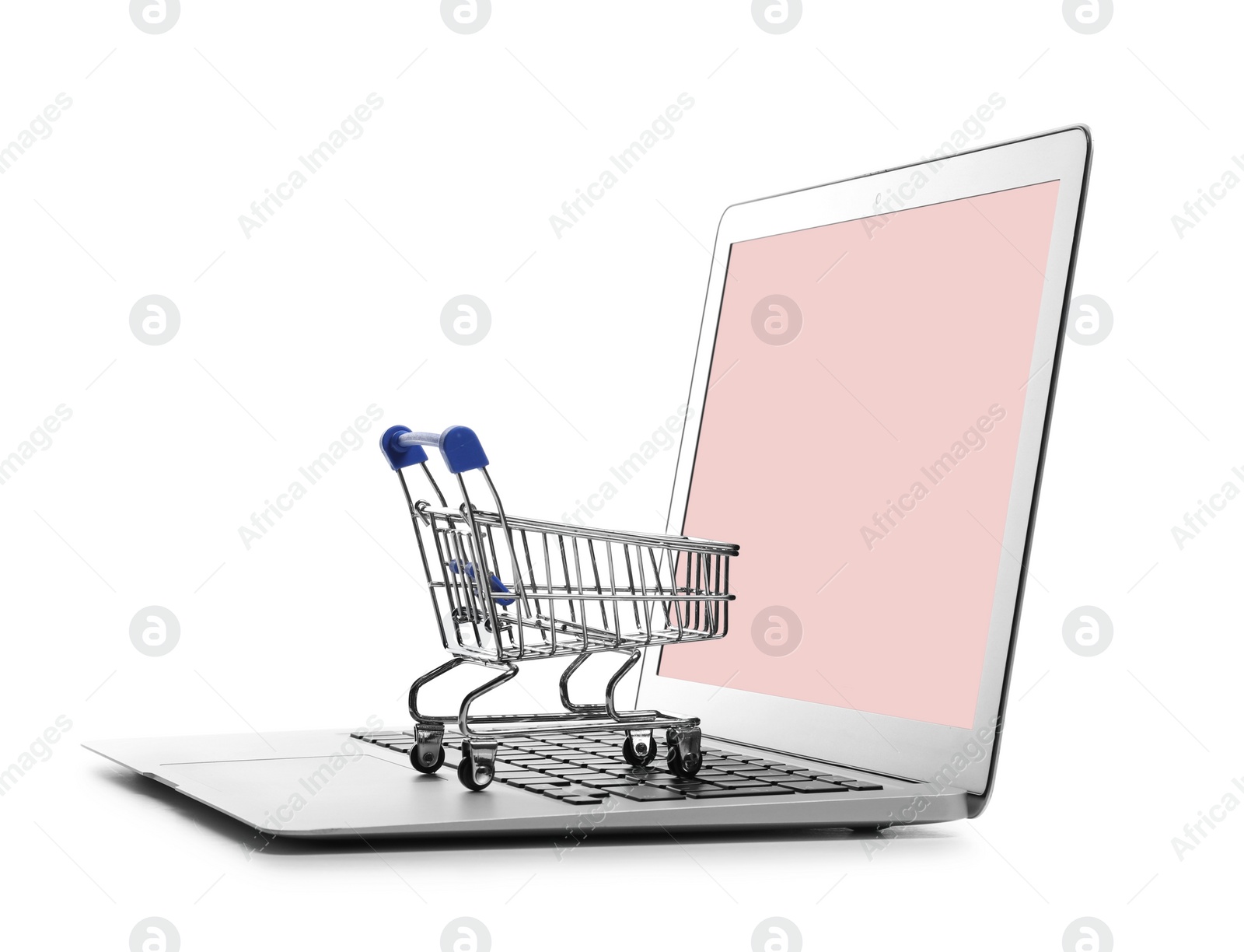 Photo of Internet shopping. Laptop with small cart isolated on white