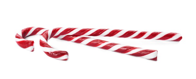 Photo of Delicious Christmas candy canes on white background