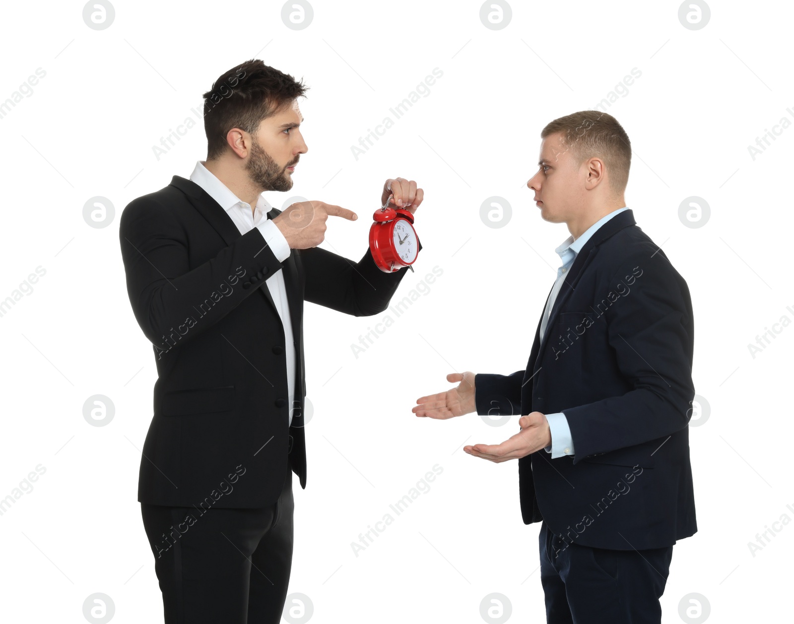 Photo of Businessman with alarm clock scolding employee for being late on white background