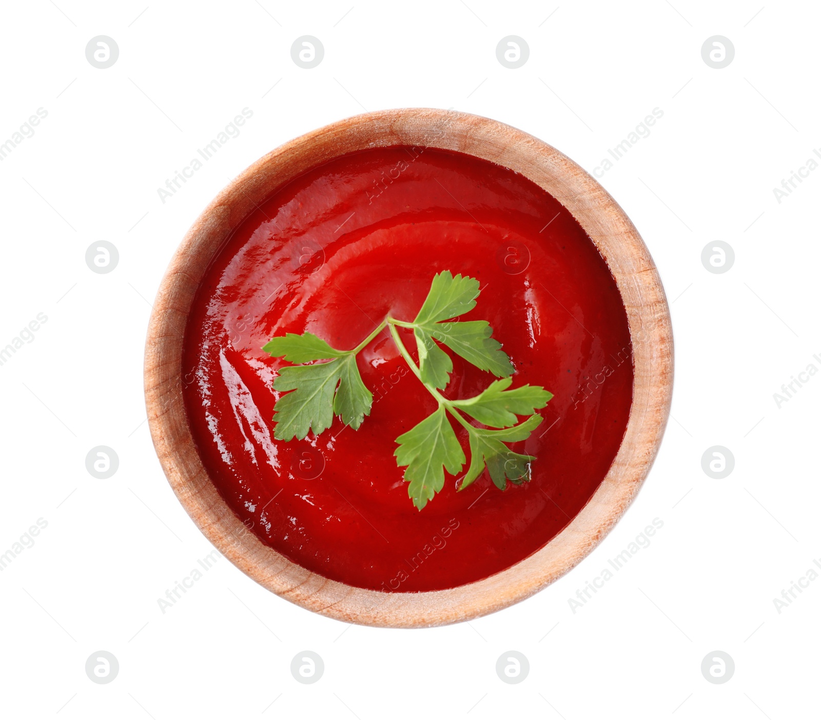 Photo of Tasty tomato sauce with parsley in wooden bowl isolated on white, top view