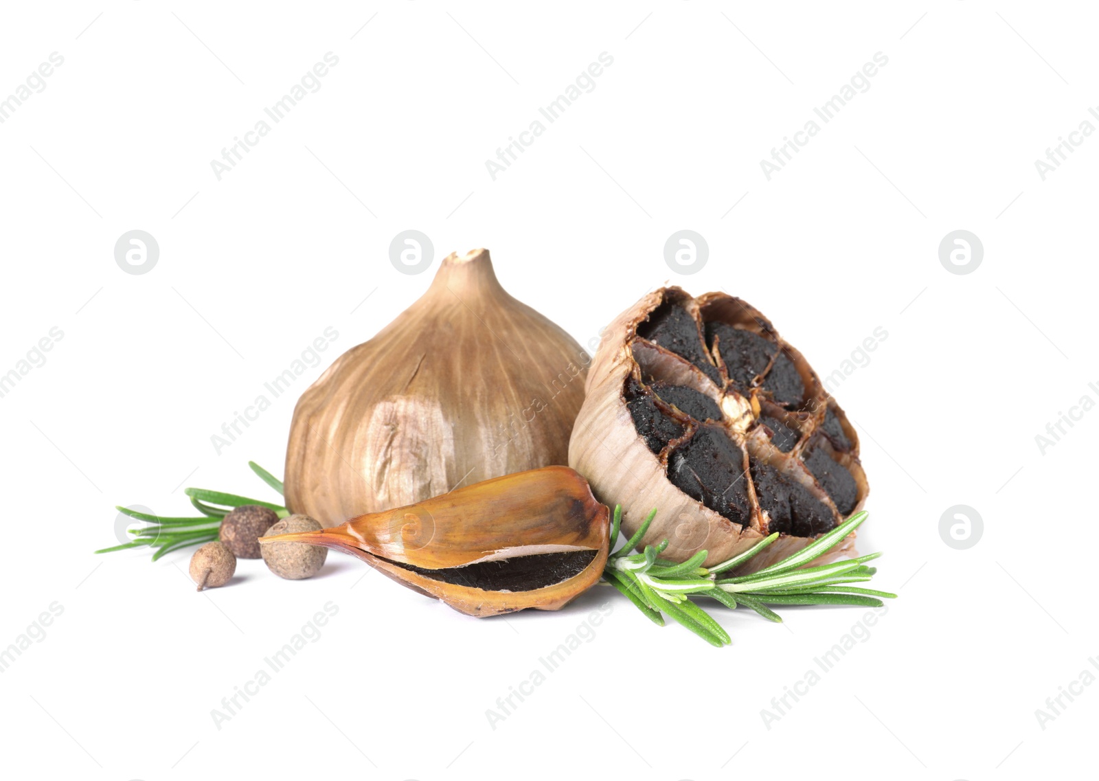 Photo of Aged black garlic with rosemary on white background