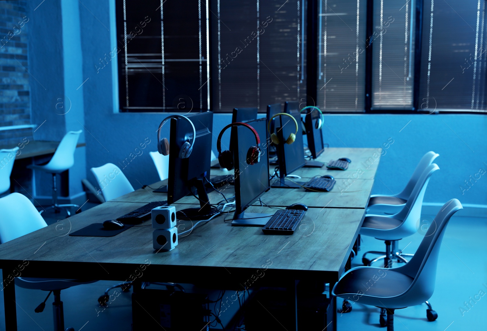 Photo of Internet cafe interior with modern computers. Video game tournament