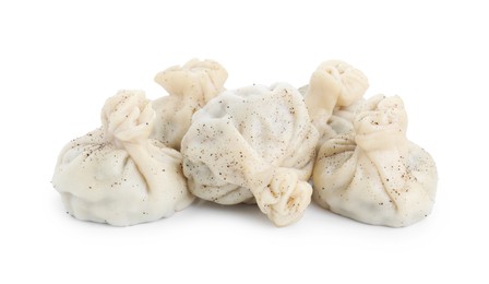 Photo of Many tasty khinkali (dumplings) and spices isolated on white. Georgian cuisine