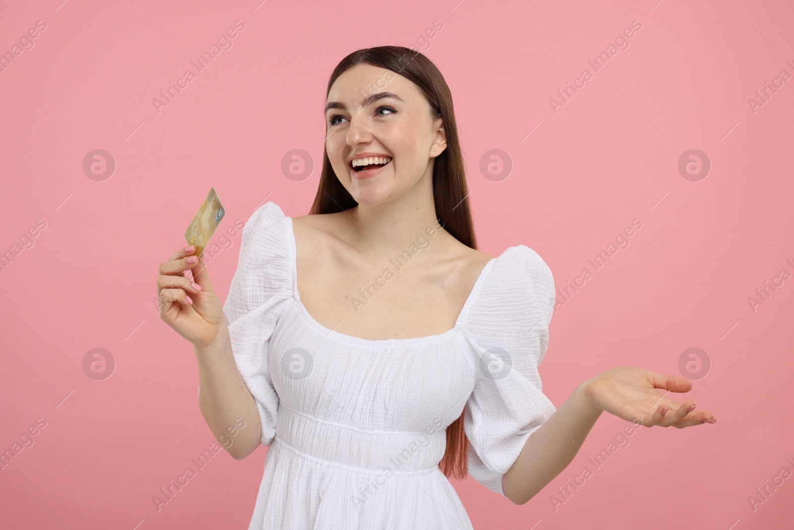 Photo of Happy woman with credit card on pink background