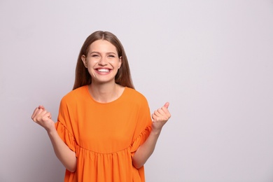 Portrait of happy young woman on white background