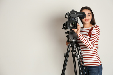 Photo of Operator with professional video camera on white background, space for text