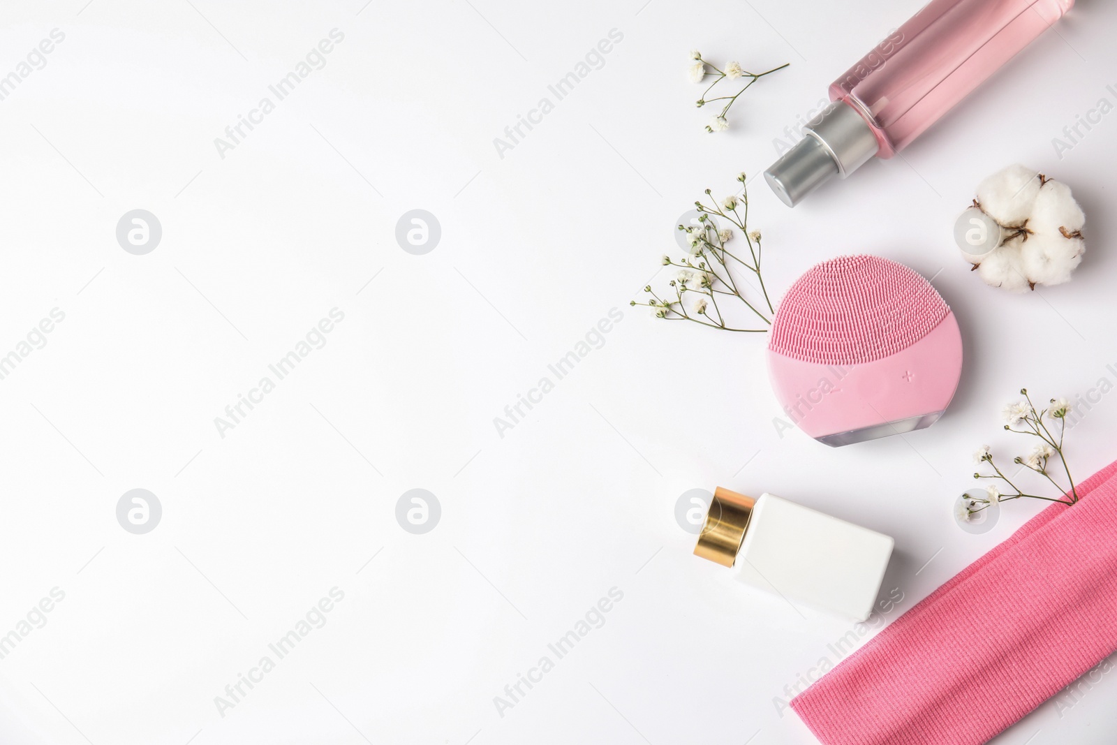 Photo of Composition with face cleansing brush on white background, top view. Cosmetic accessory