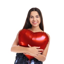 Portrait of young woman with heart shaped balloon on white background