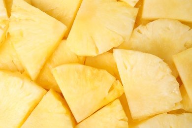 Photo of Slices of tasty ripe pineapple as background, top view