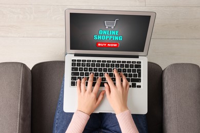 Image of Woman using laptop for online shopping in armchair indoors, top view