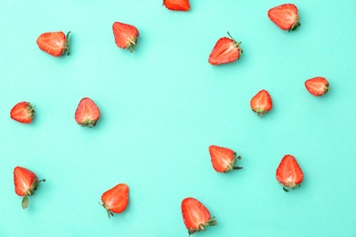 Flat lay composition with ripe red strawberries on color background