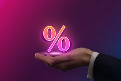 Image of Man holding virtual sign of Percent on color background, closeup. Special promotion