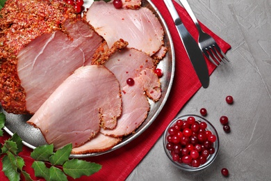 Flat lay composition with delicious ham for Christmas dinner on grey table