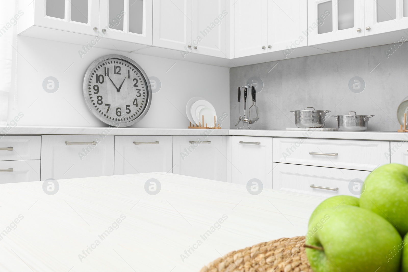 Photo of Fresh ripe apples on white wooden table in kitchen