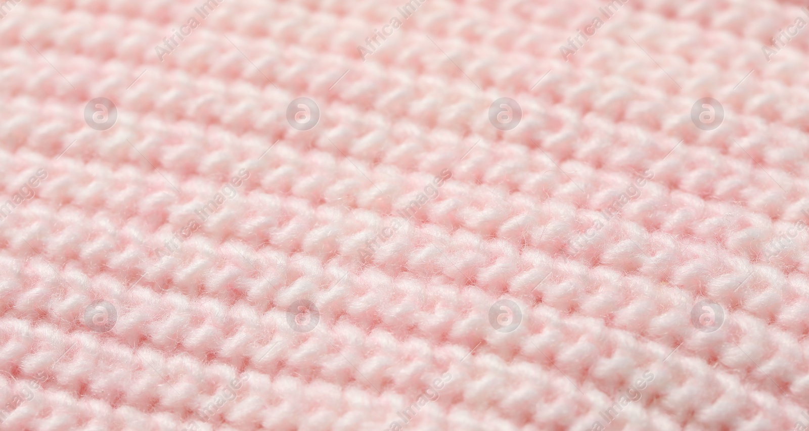 Photo of Texture of soft pink knitted fabric as background, closeup