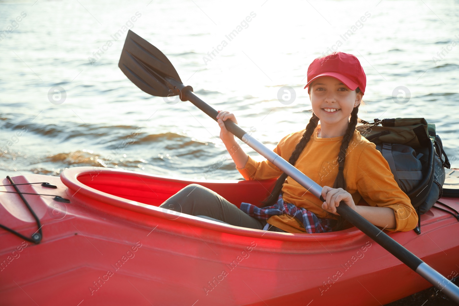 Photo of Happy girl kayaking on river. Summer camp activity