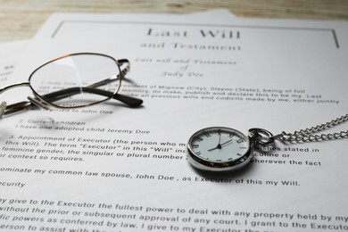 Photo of Last Will and Testament, glasses and pocket watch on table, closeup