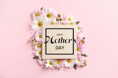 Happy Mother's Day greeting card and beautiful flowers on pink background, flat lay