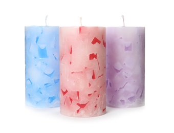 Photo of Three color wax candles on white background