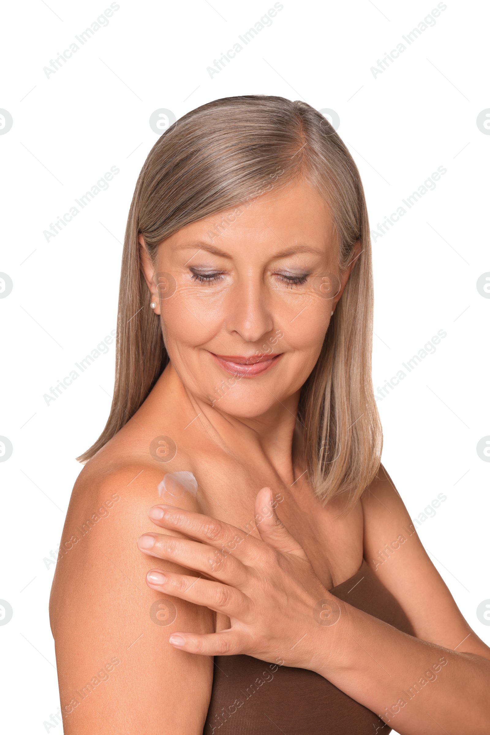 Photo of Beautiful senior woman applying sun protection cream onto her shoulder isolated on white