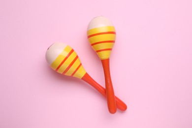 Photo of Colorful maracas on pink background, flat lay. Musical instrument