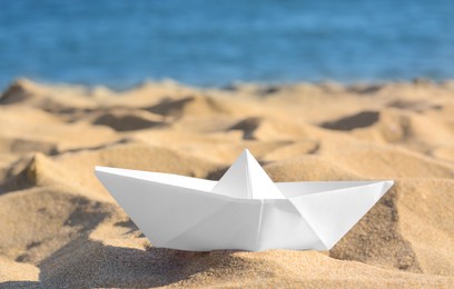 Photo of White paper boat near sea on sunny day