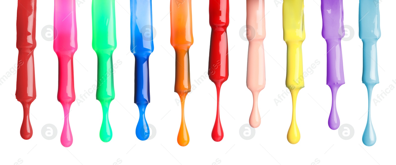 Image of Different color nail polish collection. Set of brushes with dripping liquid isolated on white