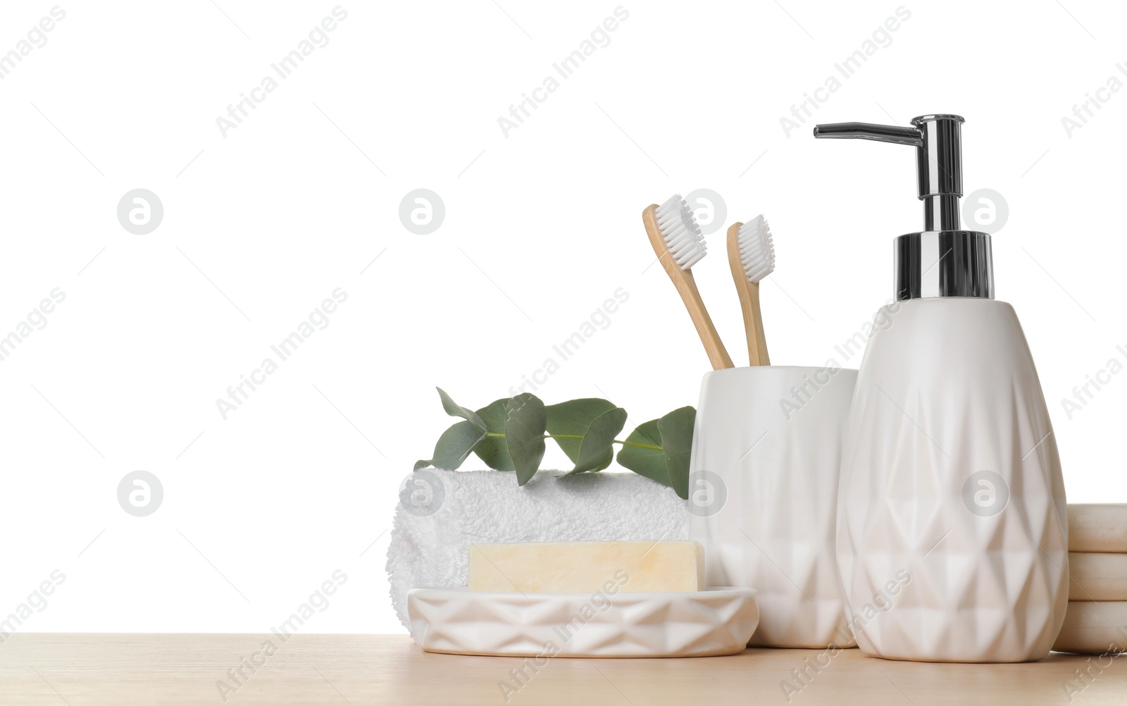 Photo of Bath accessories. Different personal care products and eucalyptus branch on wooden table against white background. Space for text