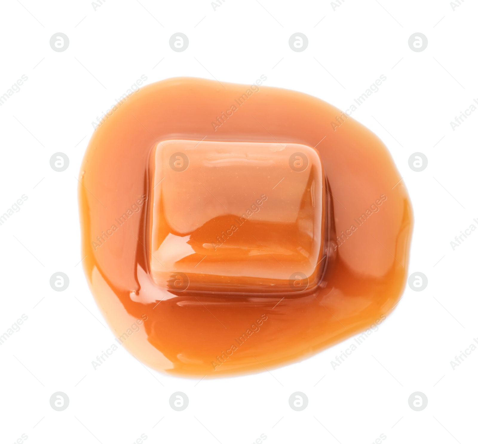 Photo of Delicious candy with caramel sauce on white background