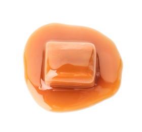 Delicious candy with caramel sauce on white background