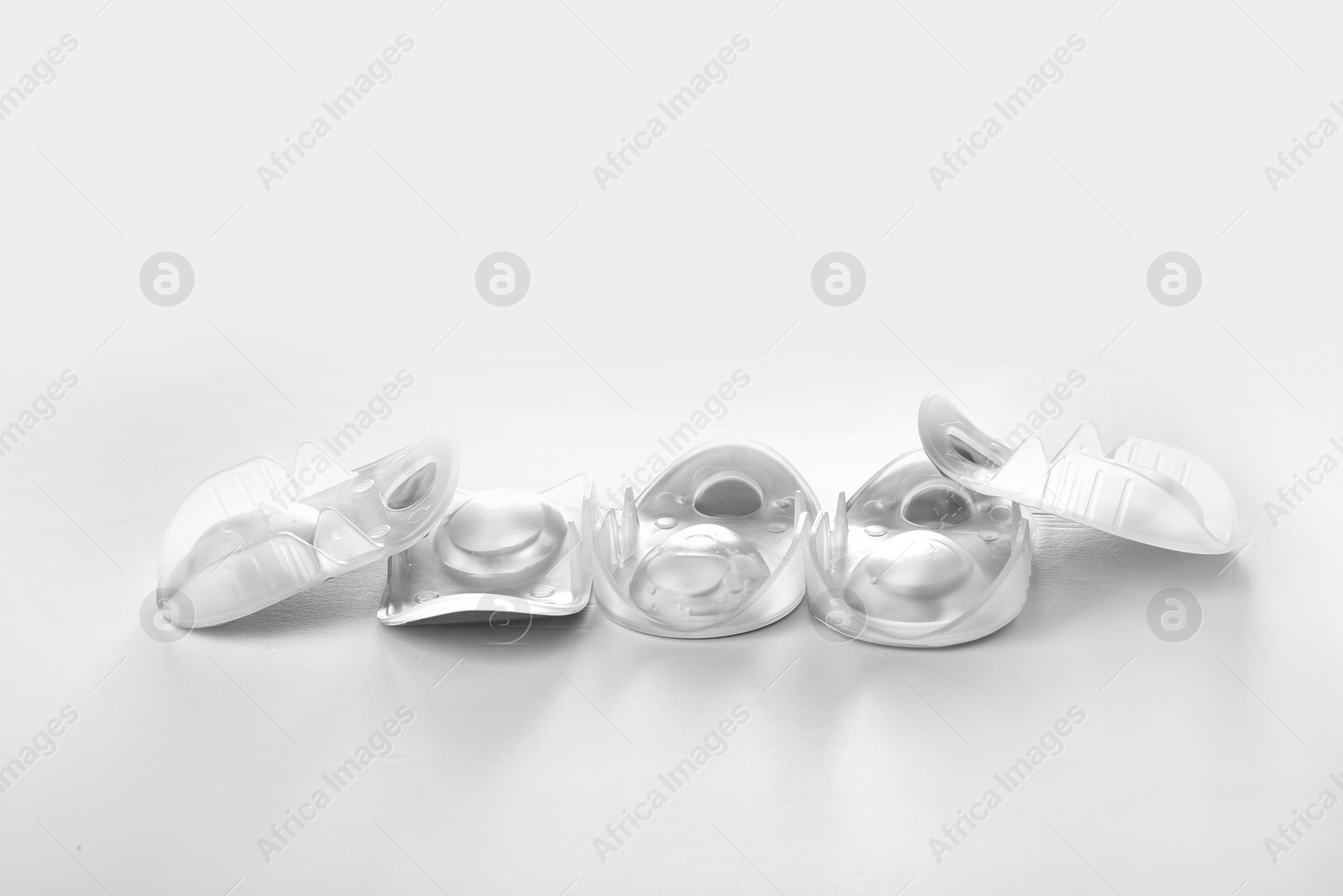 Photo of Packages with contact lenses on white background