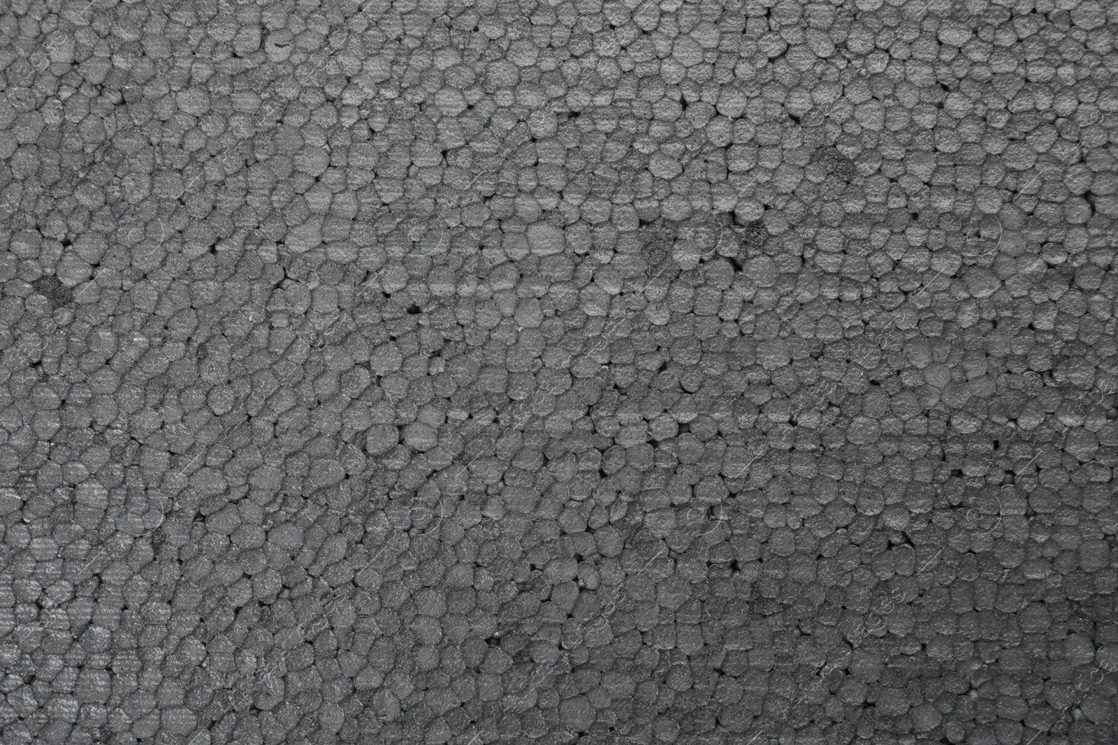 Photo of Texture of grey styrofoam sheet as background, closeup