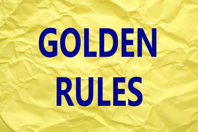 Image of Sheet of color crumpled paper with phrase GOLDEN RULES