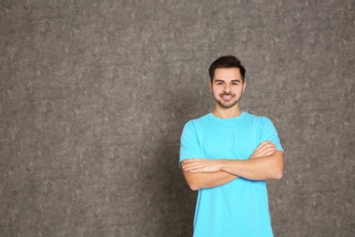 Portrait of handsome man on grey background. Space for text