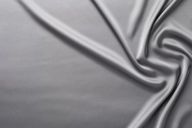 Photo of Texture of beautiful light grey silk fabric as background, closeup