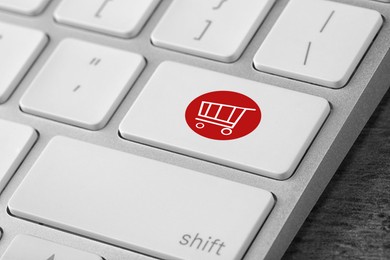 Image of Online store. Button with shopping cart on computer keyboard, closeup