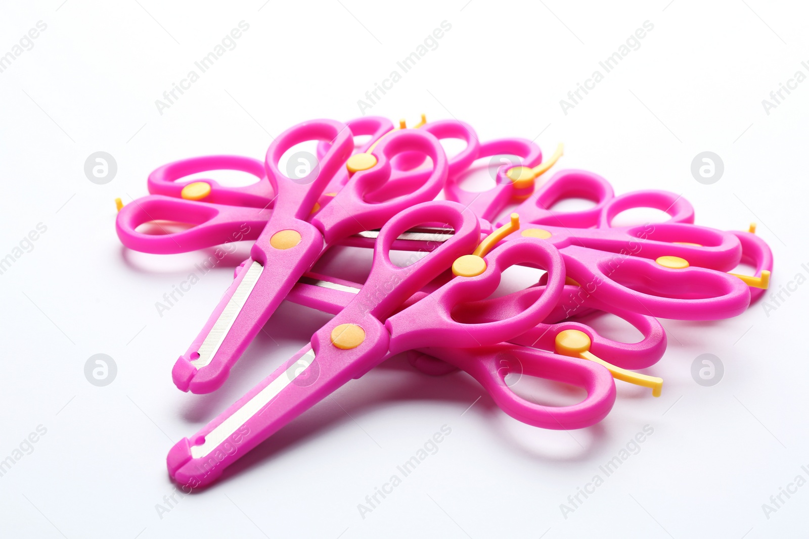 Photo of Heap of training scissors on white background