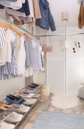 Modern dressing room with different stylish clothes and accessories