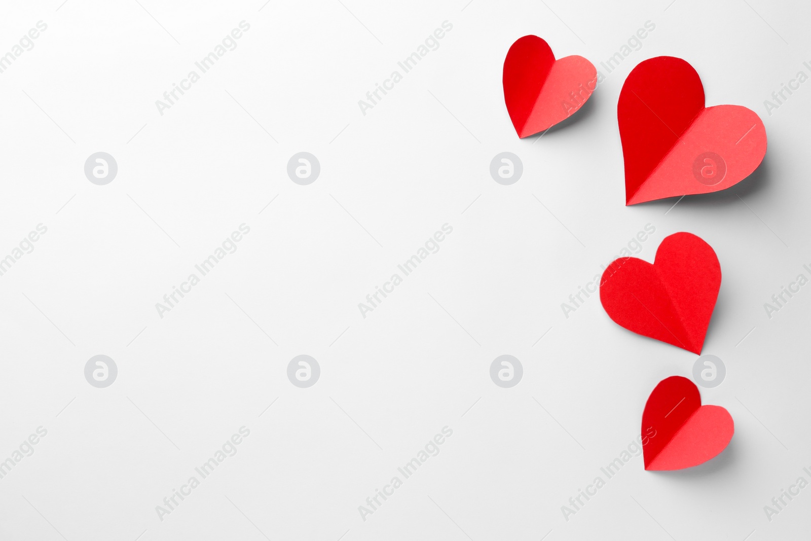 Photo of Paper hearts on white background, flat lay. Space for text