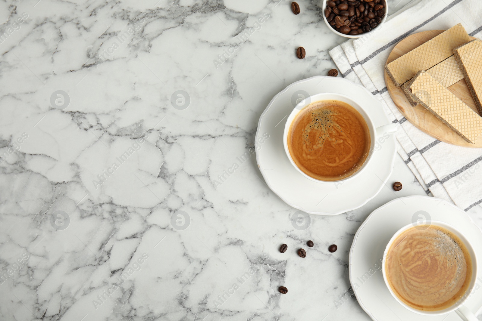 Photo of Breakfast with delicious wafers and coffee on white marble table, flat lay. Space for text