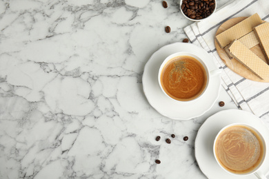 Breakfast with delicious wafers and coffee on white marble table, flat lay. Space for text