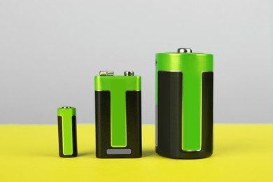 Image of Different types of batteries on color background