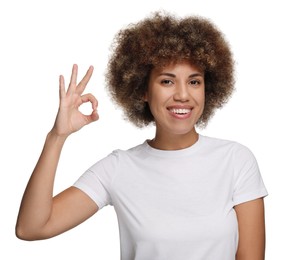 Woman with clean teeth showing OK gesture on white background