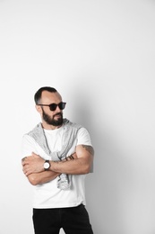 Portrait of handsome tattooed man on white background