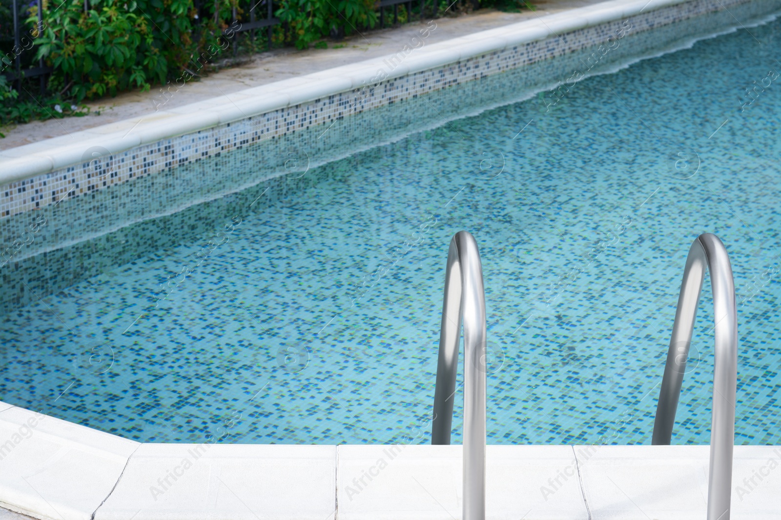 Photo of Ladder with grab bars in outdoor swimming pool