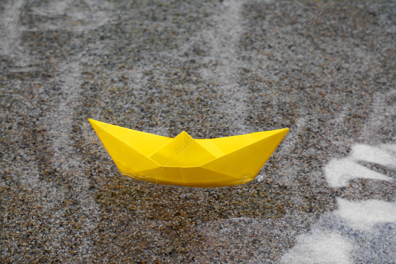 Photo of Beautiful yellow paper boat on water outdoors